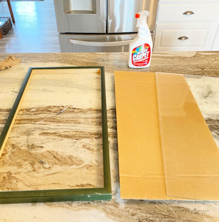 The backside of a vintage thrifted frame thats been dismantled to prepare for cleaning.