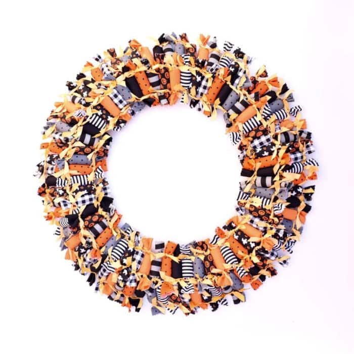 A large and colorful Candy Halloween wreath made with faux candy bundles in bright colored Halloween fabrics.