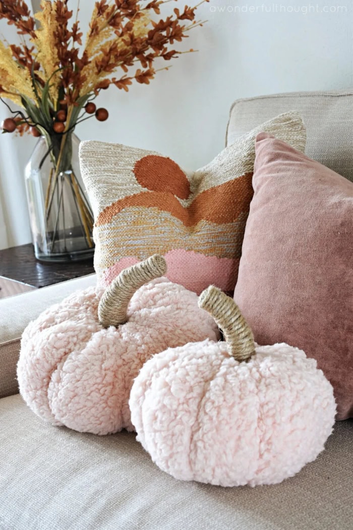 Two pottery barn inspired sherpa pumpkin pillows.  These easy diy pumpkins are  adorable made in a soft blush colored fabric.