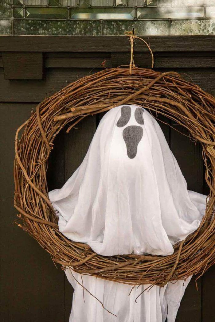 A plain grapevine wreath decorated with a large and really fun dollar store ghost.