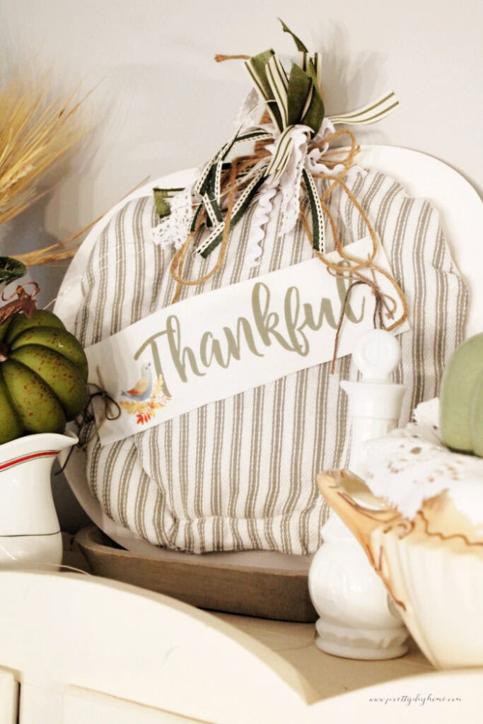 A DIY wood pumpkin painted and covered with a fabric