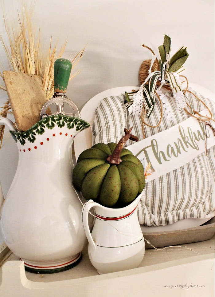 A beautiful neutral Fall decor arrangment in creams and greens. The fall decor features a beautiful Dollar Tree pumpkin craft idea for adults.