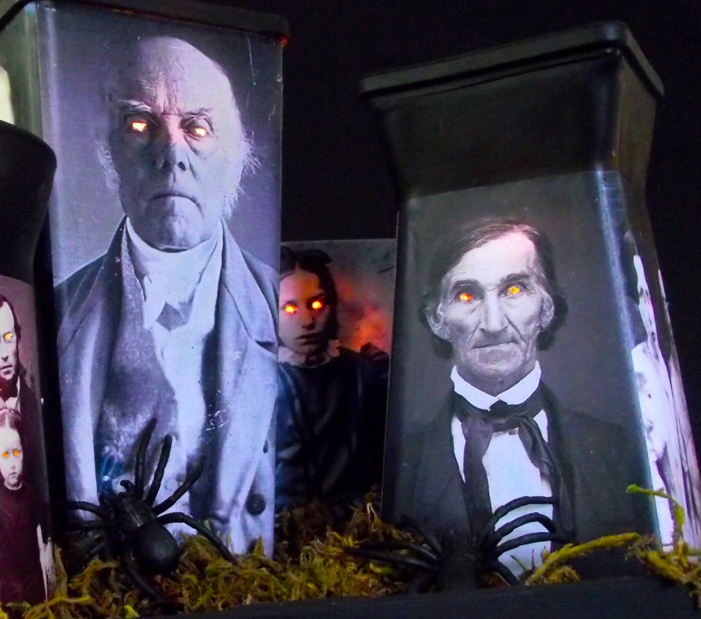 A set of very creepy votive made with images that have the eyes cut out. The light inside the lanterns are making the eyes glow. A really scary Halloween centerpiece decoration.