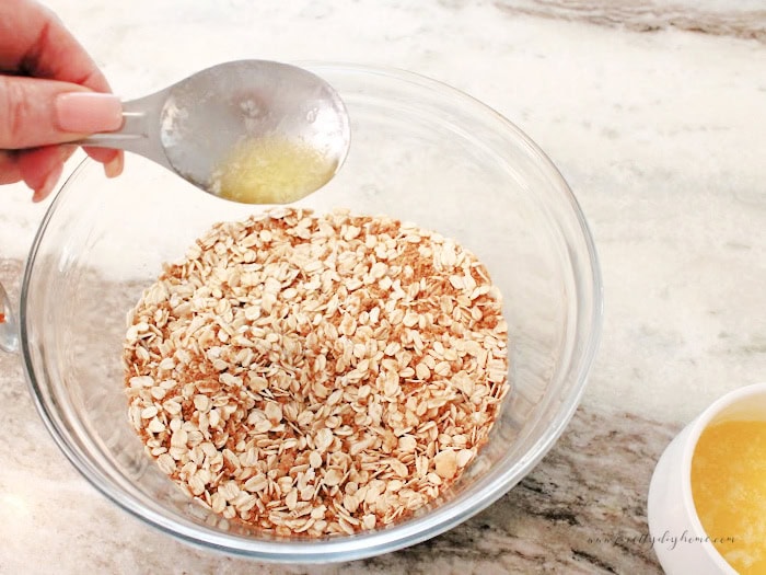 Adding butter to a gingersnap and oatmeal granola.