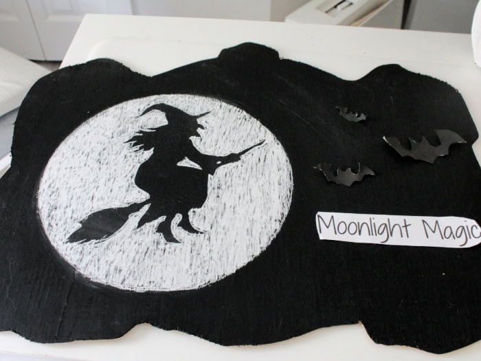 A closeup of the witch silhouette done inside a circle to mimic a full moon.