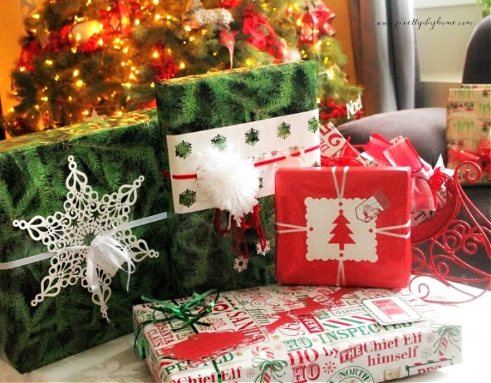 Four beautifully wrapped Christmas presents so they can safely be placed in the mail. They gifts have flat embellishments instead of puffy ribbons that will flatten and rip