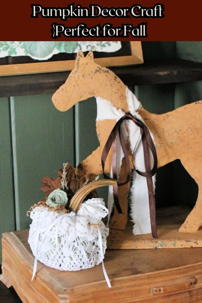 A vintage thrift store doily is turned into a pumpkin, and decorated so as not to damage the vintage doily.