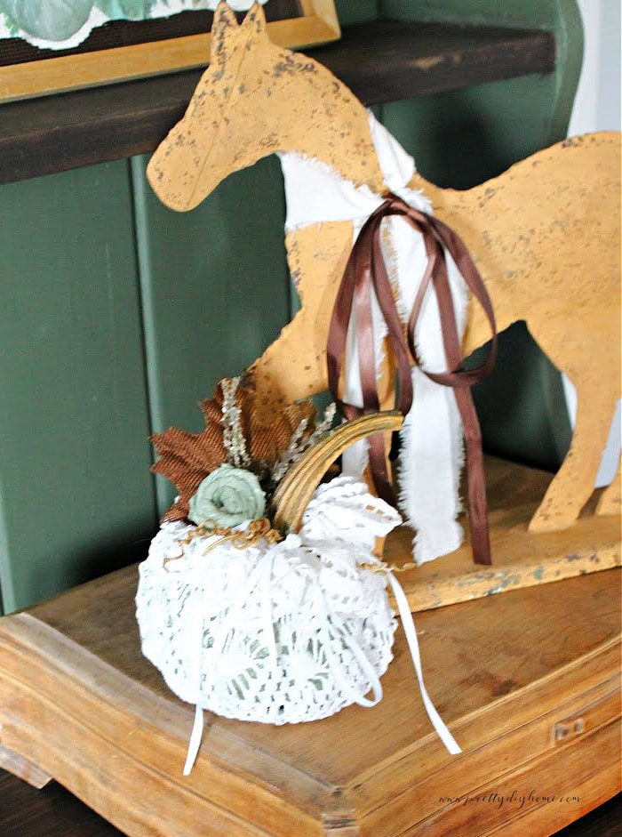 A Dollar Tree pumpkin fall craft made with a doily  A vintage doily creates a beautiful fall pumpkin with a real stem.  an easy and affordable fall craft with a dollar tree pumpkin and thrift store vintage doily.