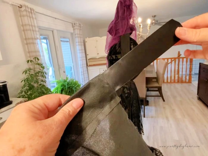 The cape for a DIY witch, showing a pretty ribbon for tying