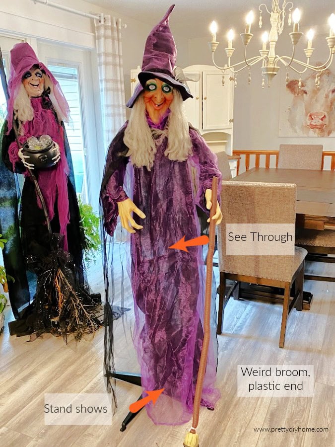 A inexpensive purchased witch on her stand with arrows pointing to her see through fabric, a stand that shows, 