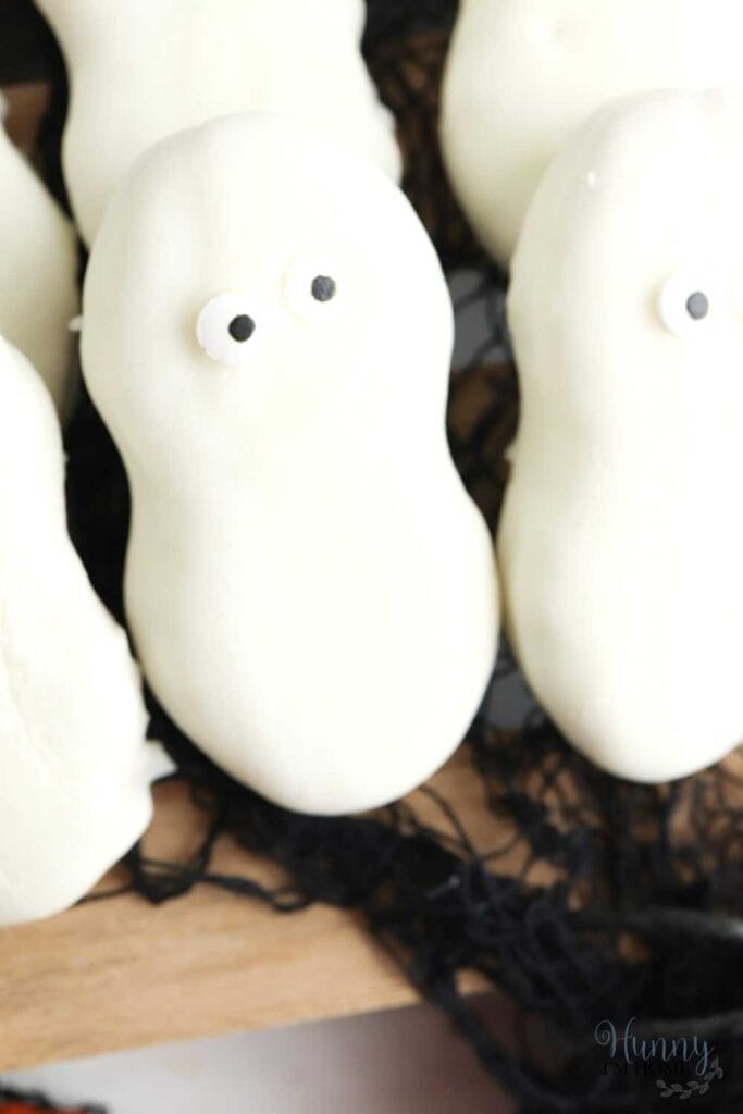 Nutter butter cookies covered in white dipping chocolate with two little candy eyeball