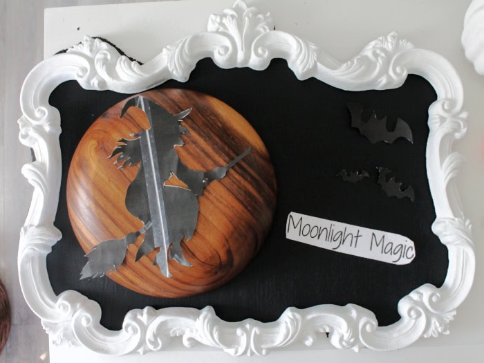 Aligning the template for chalk artboard, you can see a bowl to be outlined for the moon, the witch ontop of the bowl the wording to the right, and the bats in the upper corner
