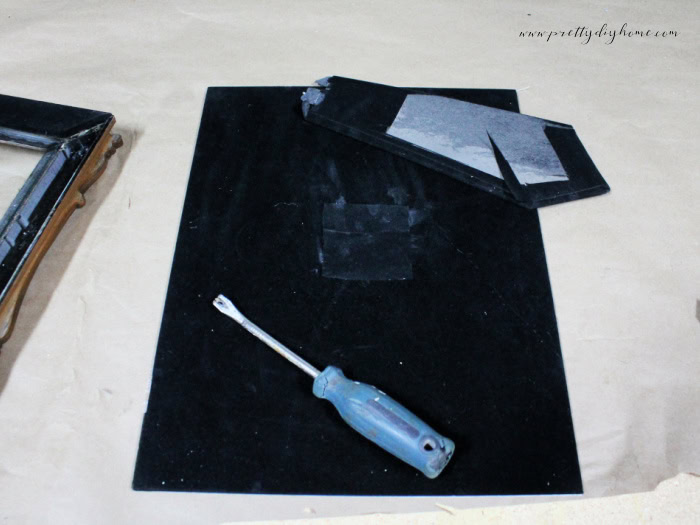 Showing the back of a DIY Halloween decoration frame with the back stand removed and repaired.