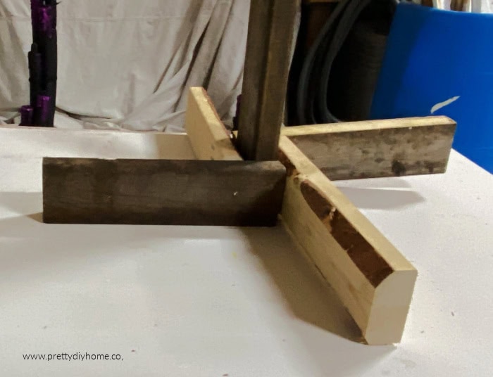 Easy to build and solid base for a witch made out of two by fours screwed around the base for stability.