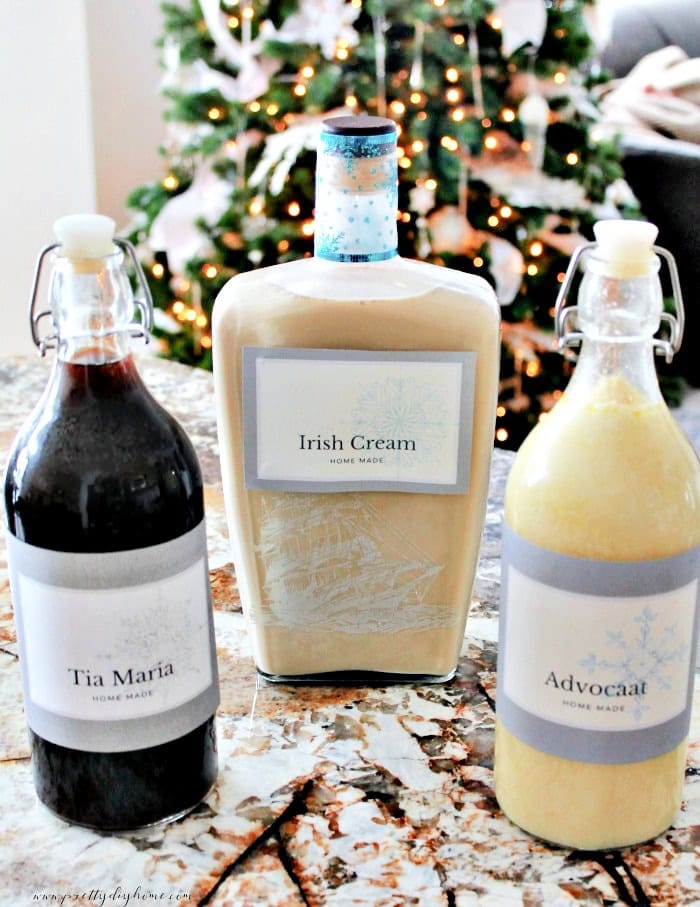 Homemade bottles of Tia Maria, Irish Cream, and Advocaat with matching printable labels arranged together.