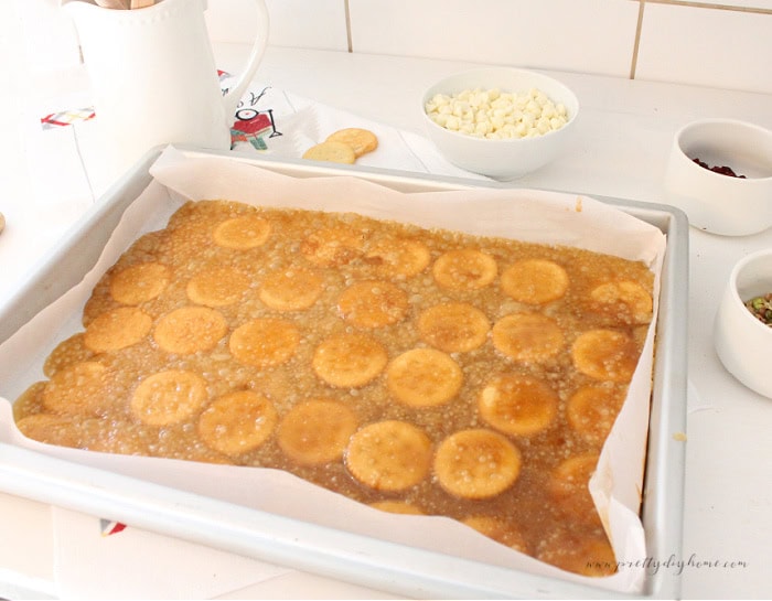 Baked layer of toffee and crackers cooling on sheet