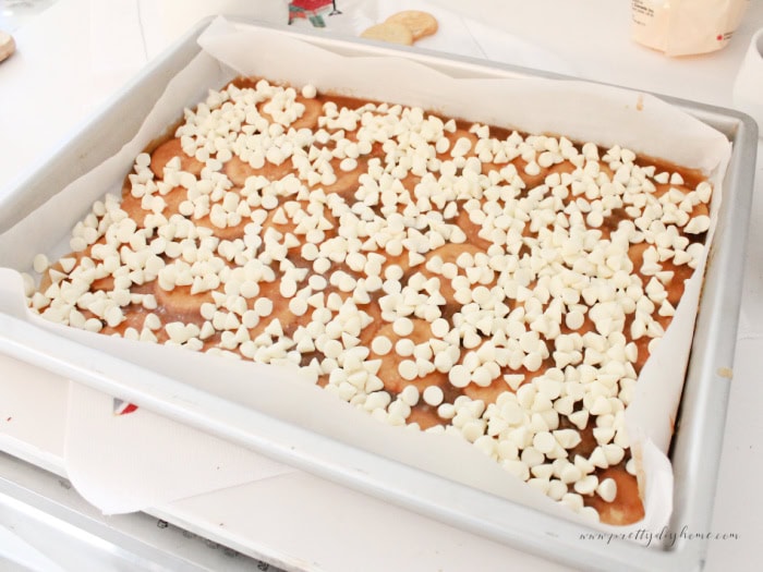 White chocolate chips melting on warm toffee layer