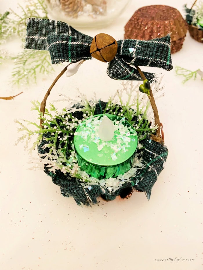 DIY vintage tart tin Christmas tree ornaments with tartan fabric, glittered brown tins, and small flameless candles.