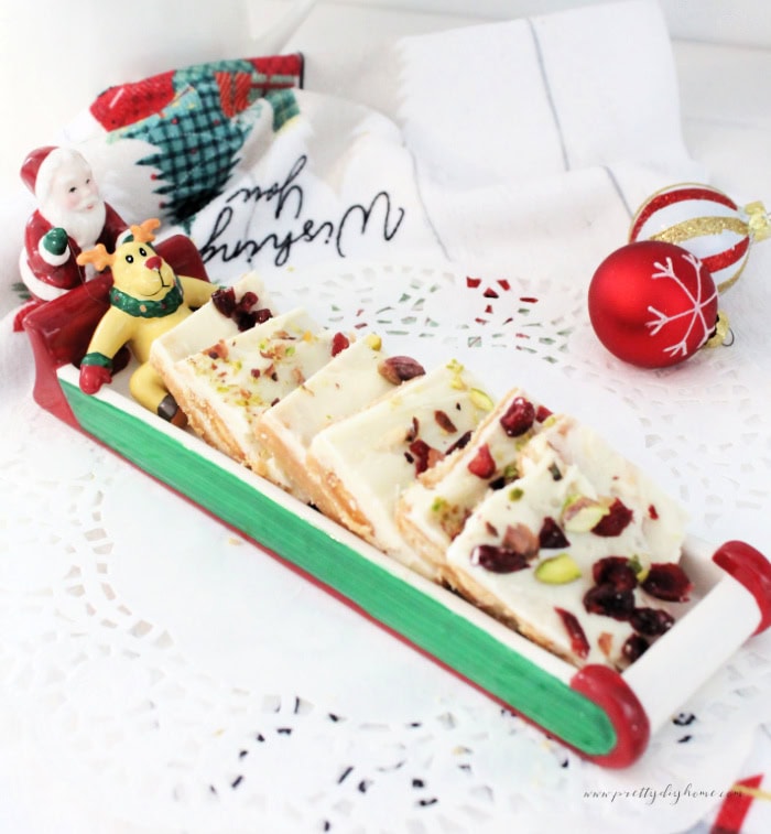 White chocolate cranberry pistachio toffee in a vintage Santa candy dish.
