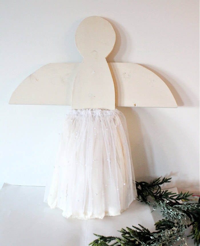 Wooden Christmas angel with both the muslin base layer and the pearl tulle overlay tied on, creating a soft and feminine cottage core skirt.
