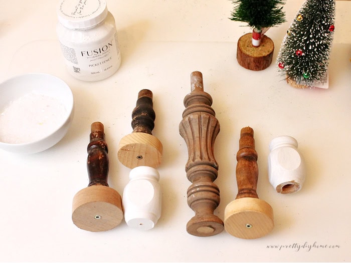 Supplies for making vintage style spindle bases with paints, spindles, and bottle brush trees for Christmas decor.
