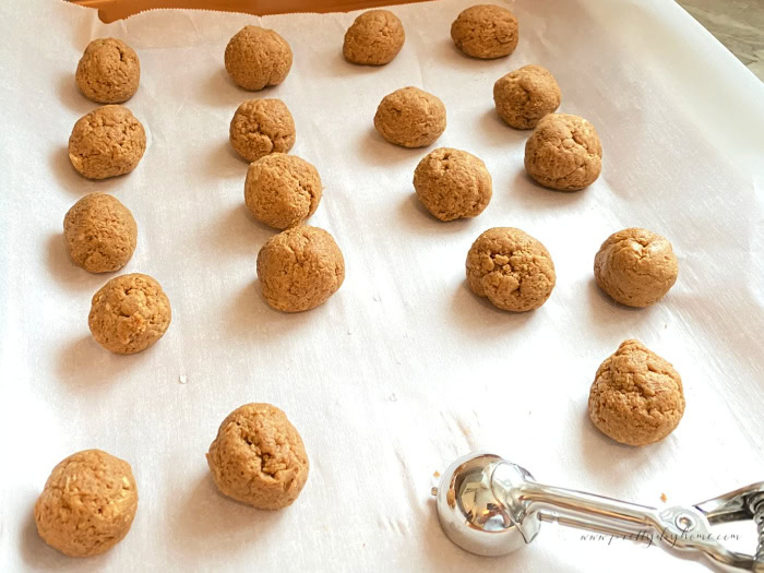 Rolling gingerbread truffle dough into balls with a small cookie scoop.
