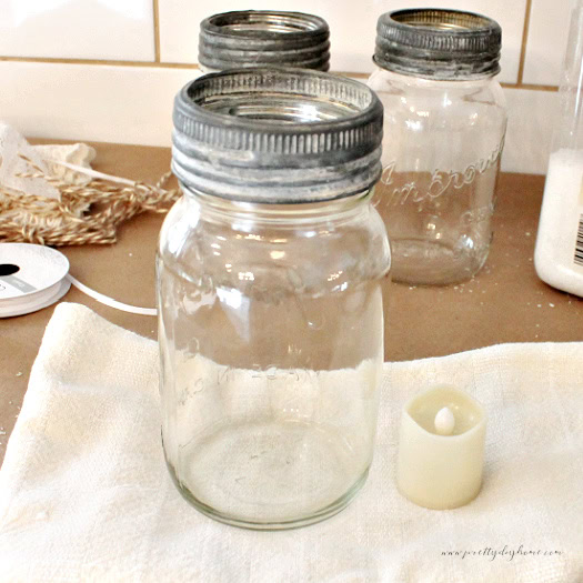 Judging Mod Podge height on a mason jar by lining it beside a candle..