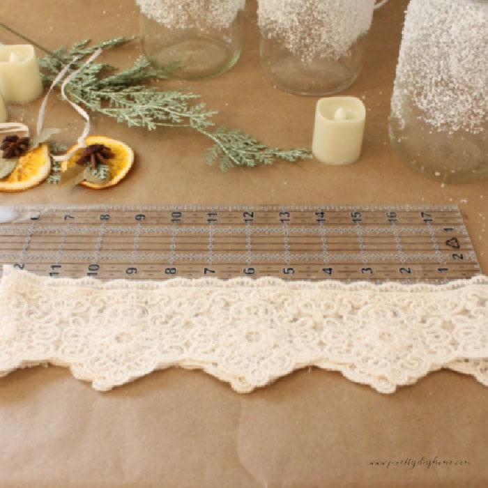 Measuring 18 inches of lace to gather and wrap around a mason jar.