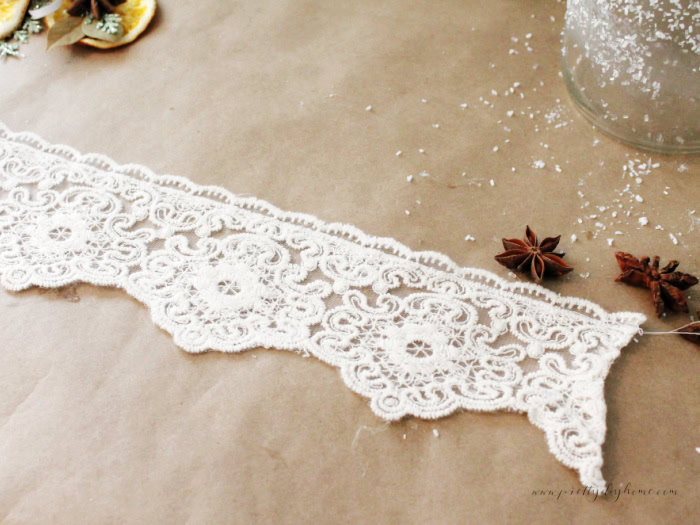Sewing lace with quarter-inch stitches and long tails for gathering around a mason jar.