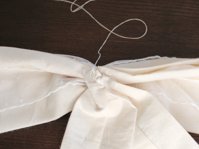 Attaching the fabric bow tails to the back of the bow