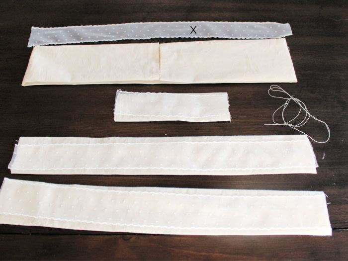 Fabric bow pieces sewn into tubes with matching lace layers