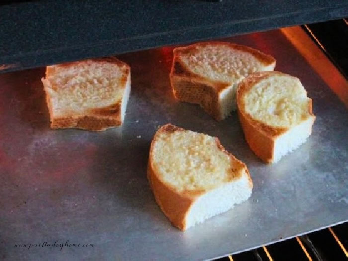 Garlic buttered bread toasting in the oven for French onion soup