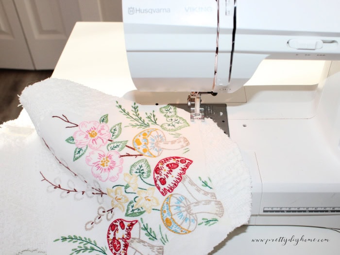 Sewing embroidered linen appliqué onto a DIY Easter bunny using a zig zag stitch