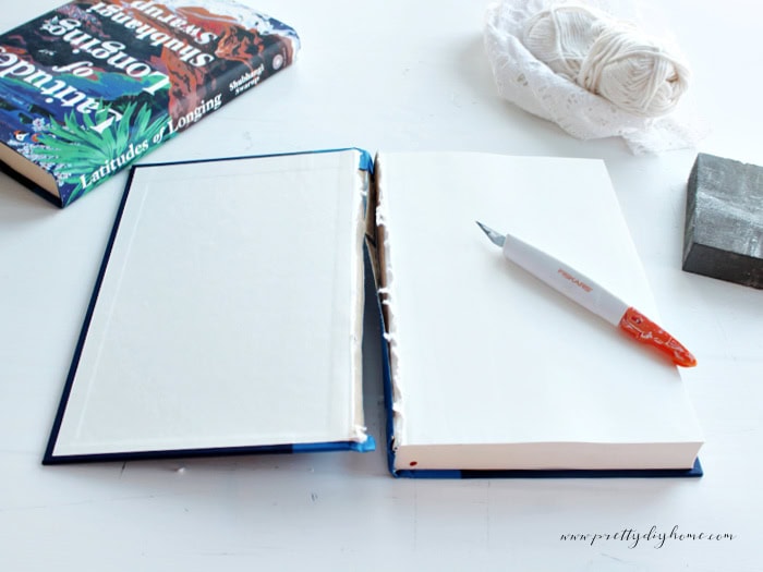 Removing the cover from a hardcover book to create a decorative book stack