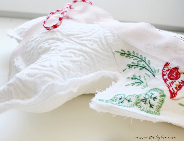 Close up of open edge seam showing fabric and quilt batting layers in a DIY Easter bunny.