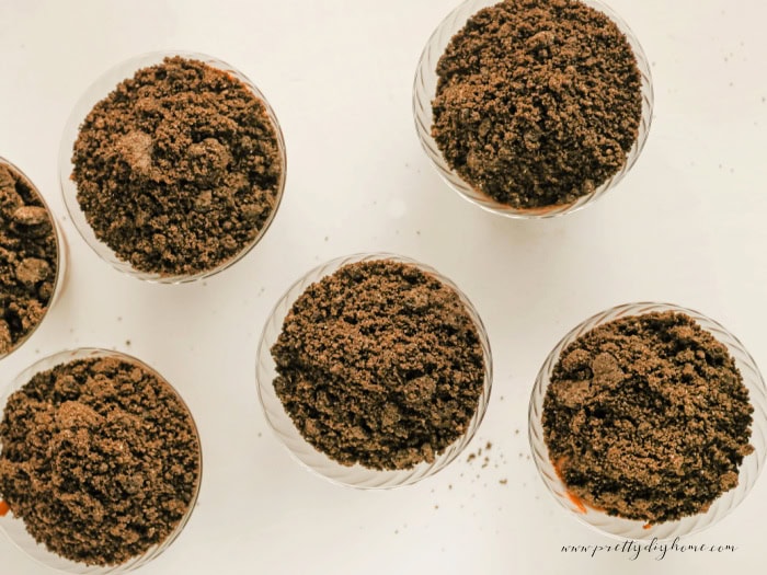 Chocolate pudding cups topped with crushed Oreo crumbs to create the dirt layer for Easter dirt cups