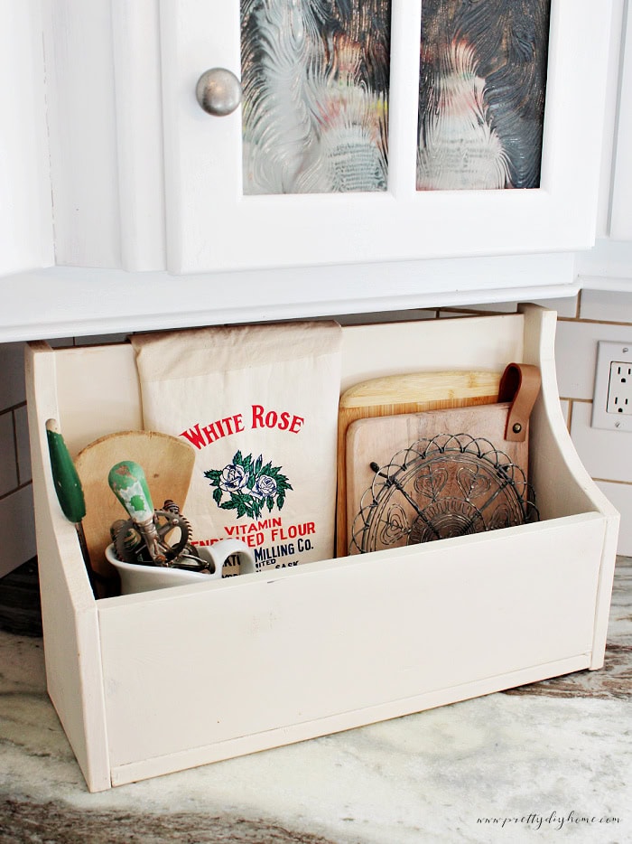 Vintage flour sack displayed with wooden kitchen organizer and vintage kitchen tools