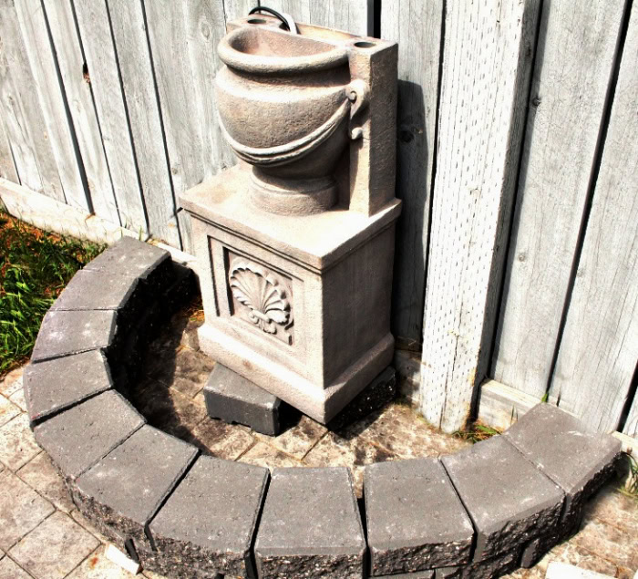 Leveling the flower bed base for the garden water fountain.