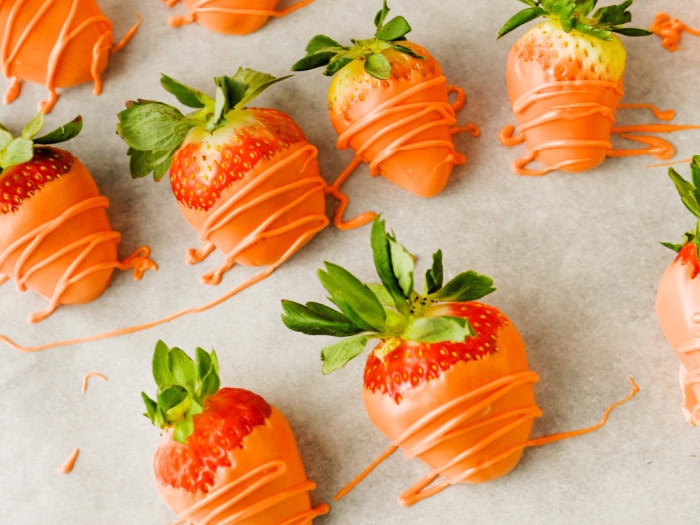Strawberries dipped in orange candy melts to look like carrots for Easter dirt cups