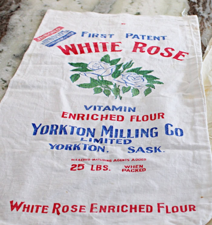 Vintage white rose flour sack Yorkton Saskatchewan with colorful graphics.