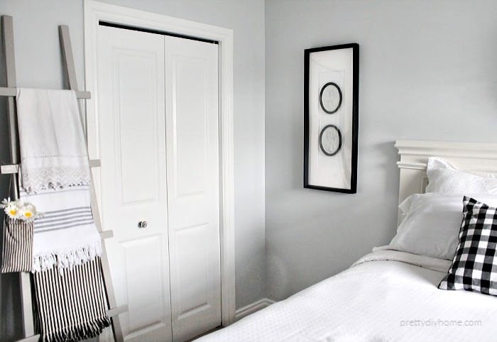 DIY bedroom ideas including a hand made bed, DIY cameo art and a wood blanket ladder.