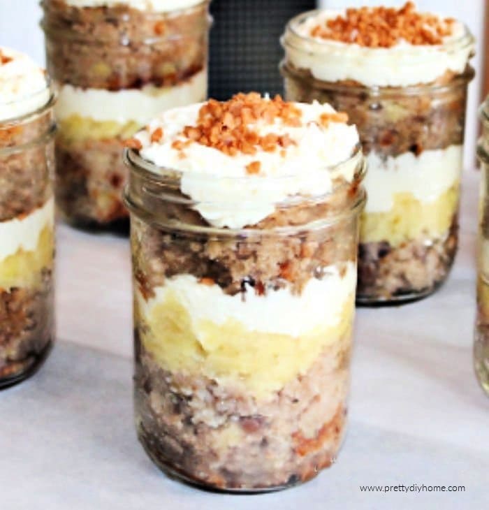 Several Hummingbird cakes served as cake in a jar with layers of cream cheese icing, skor bits and pineapple.