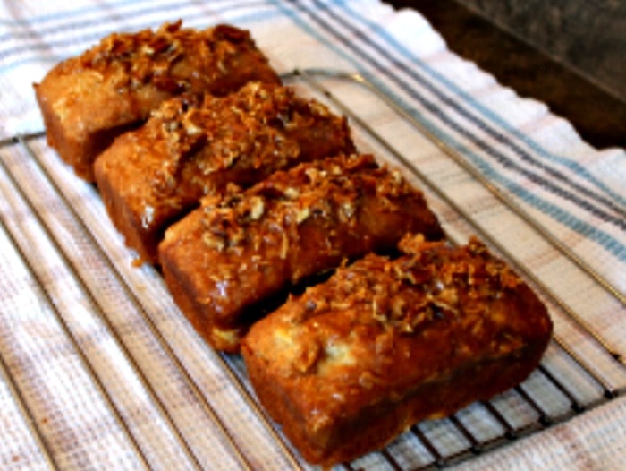 Banana loaf recipe with coconut and lime glaze cooling on a rack. This is a ultra moist banana bread