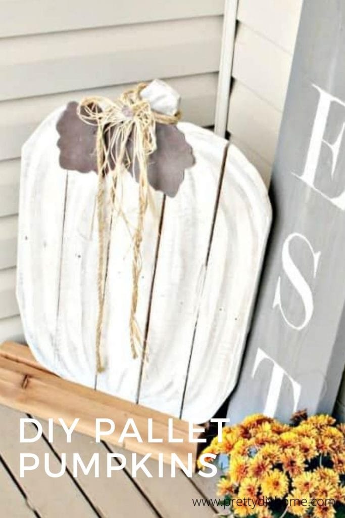 Large wood DIY Wood Pumpkin for the front porch. In white with a grey sign and gold flowers.