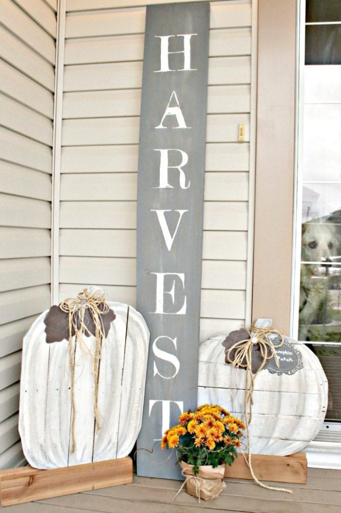 A set of large neutral pallet pumpkins for a Fall Front Porch