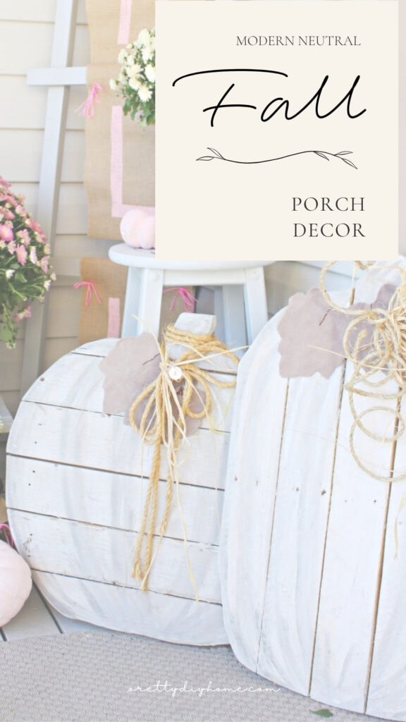 Modern neutral fall porch decor with large white DIY wood pumpkins, pink mums, and a burlap ladder banner