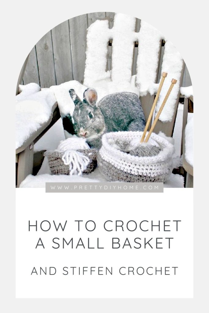 Two handmade small crochet baskets sitting outside in the winter.  One basket is holding wool and knitting needles.