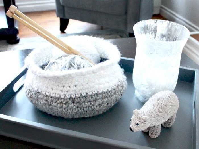 A small crochet basket made using a free crochet pattern.  The basket is grey on the bottom and white on the top.