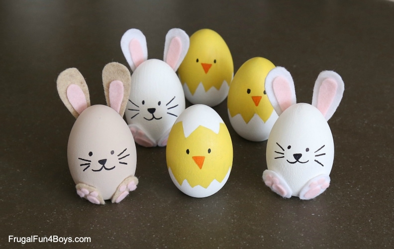 Six decorated Easter eggs that look like chicks and bunnies.  The chicks are yellow with white tops and the bunnies are painted with felt ears.