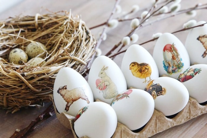 White Easter eggs decorated with various Easter themed Easter tattoos, birds, lambs bunnies.